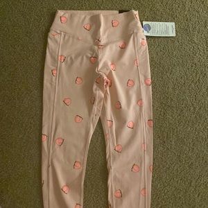 Brand new pink brand leggings.  Design peaches.  In size large